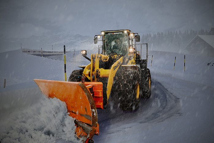 snow-plower pushing snow in a storm